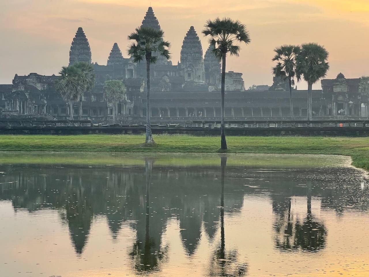 Angkor Wat reflected in a pool at sunrise